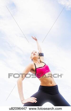Woman exercising outdoors View Large Photo Image Stock Photo - Woman exercising outdoors. Fotosearch