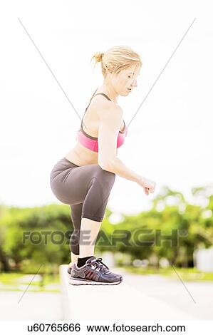 Woman exercising outdoors View Large Photo Image Stock Photograph - Woman exercising outdoors. Fotosearch