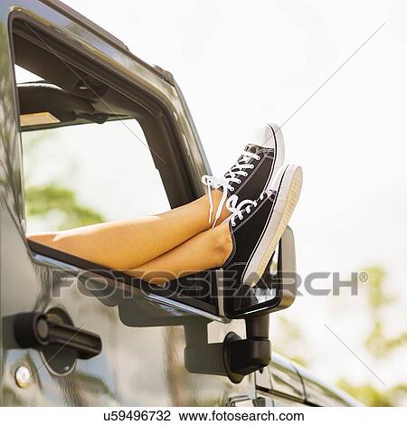 Woman keeping legs outside car View Large Photo Image Stock Image - Woman keeping legs outside car. Fotosearch