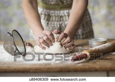 Stock Photo - Woman kneading dough. Fotosearch