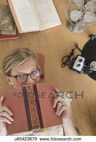 Woman lying down on floor and peeking View Large Photo Image Stock Photo - Woman lying down on floor and peeking. Fotosearch
