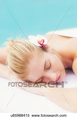 Woman lying next to swimming pool View Large Photo Image Stock Photography - Woman lying next to swimming pool. Fotosearch