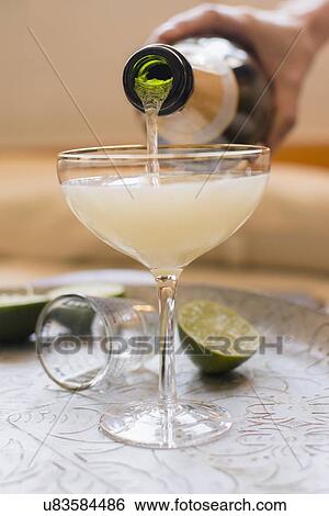Woman mixing champagne with cocktail View Large Photo Image Stock Photograph - Woman mixing champagne with cocktail. Fotosearch