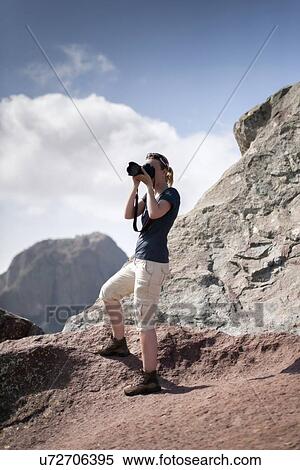 Woman photographing in mountains View Large Photo Image Stock Photography - Woman photographing in mountains. Fotosearch