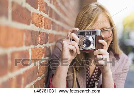 Woman photographing with vintage camera View Large Photo Image Stock Image - Woman photographing with vintage camera . Fotosearch
