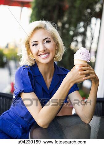Stock Photo - Woman posing with ice-cream. Fotosearch