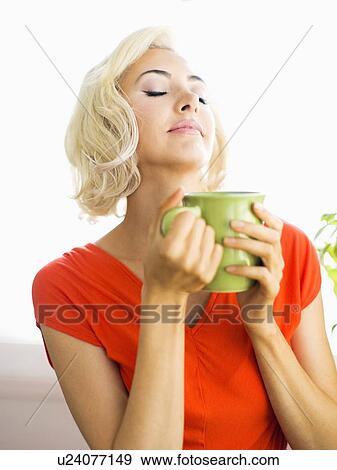 Stock Photo - Woman relaxing with cup of coffee. Fotosearch