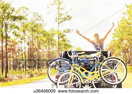 Stock Photo - Woman rising hands in car. Fotosearch