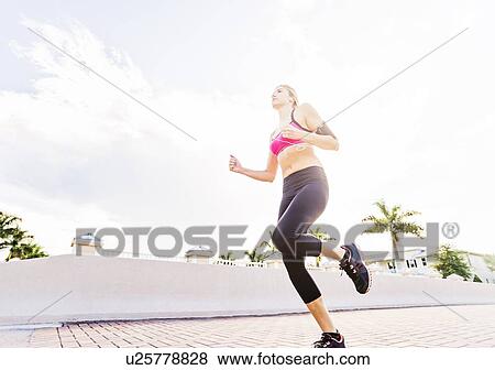 Woman running along promenade View Large Photo Image Stock Photo - Woman running along promenade. Fotosearch