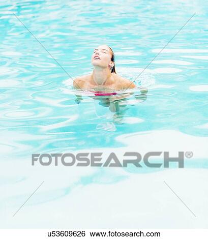 Stock Photograph - Woman swimming in swimming pool. Fotosearch