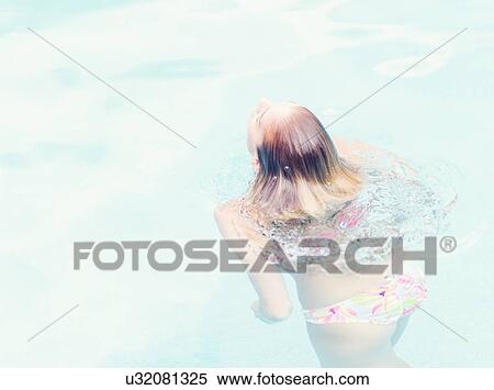 Stock Photography - Woman swimming in swimming pool. Fotosearch