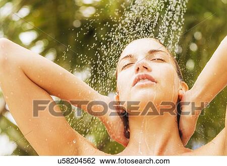 Woman taking shower outdoors View Large Photo Image Stock Image - Woman taking shower outdoors. Fotosearch