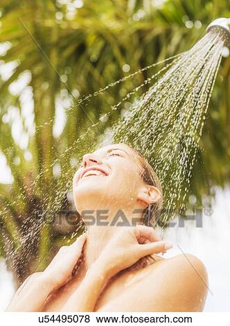 Stock Photo - Woman taking shower outdoors. Fotosearch