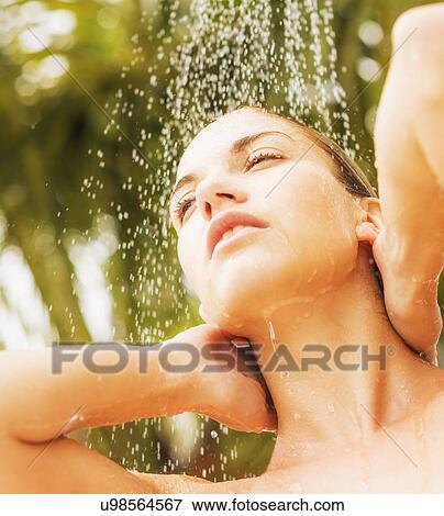 Stock Photo - Woman taking shower outdoors. Fotosearch