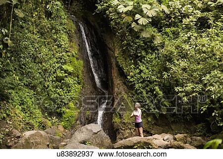 Woman under waterfall View Large Photo Image Stock Photo - Woman under waterfall. Fotosearch