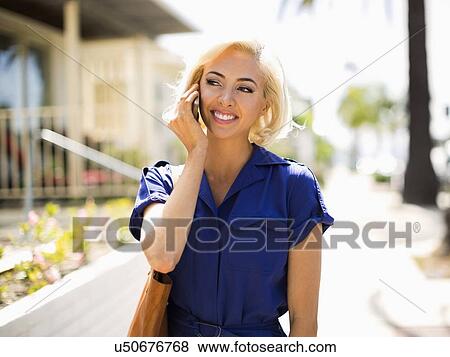 Woman using phone and walking street View Large Photo Image Stock Photo - Woman using phone and walking street. Fotosearch