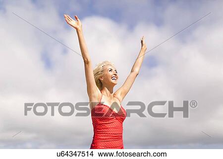 Woman wearing red one piece swimsuit rising arms and smiling View Large Photo Image Picture - Woman wearing red one piece swimsuit rising arms and smiling. Fotosearch