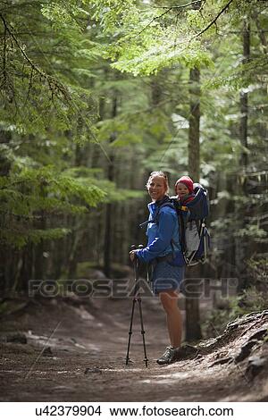 Picture - Woman with son (4-5) on trail of cedars. Fotosearch
