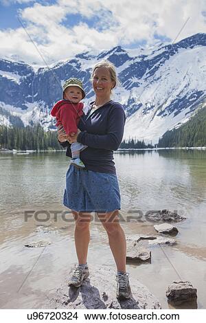 Picture - Woman with son (4-5) standing on lakeshore. Fotosearch