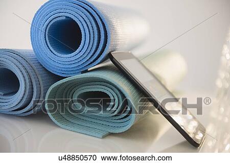 Stock Image - Yoga mats and digital tablet. Fotosearch