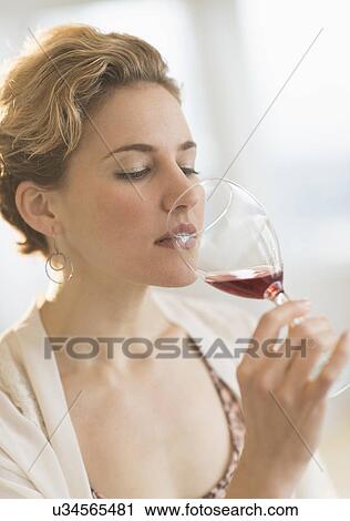 Young woman drinking red wine View Large Photo Image Stock Image - Young woman drinking red wine. Fotosearch