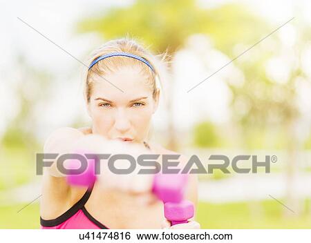 Young woman exercising in park View Large Photo Image Stock Photograph - Young woman exercising in park. Fotosearch