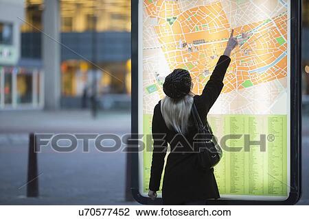Young woman pointing at city map View Large Photo Image Stock Image - Young woman pointing at city map. Fotosearch