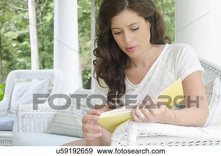 Stock Photo - Young woman reading. Fotosearch