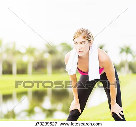 Young woman resting during work-out View Large Photo Image Stock Photo - Young woman resting during work-out. Fotosearch