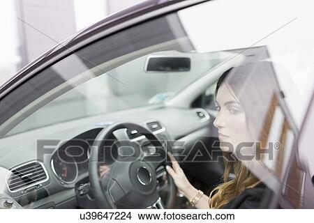 Young woman sitting in car View Large Photo Image Picture - Young woman sitting in car. Fotosearch