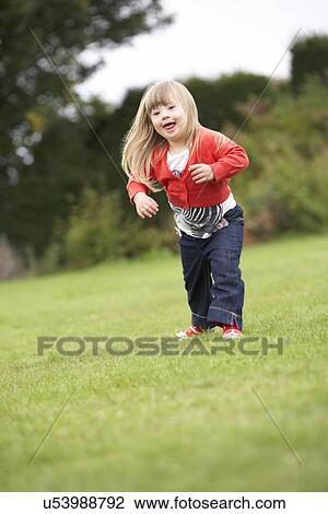 Stock Image - 3 year old girl with Downs Syndrome. Fotosearch
