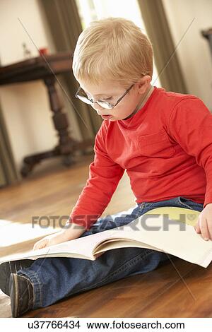 4 year old boy with Downs Syndrome reading View Large Photo Image Picture - 4 year old boy with Downs Syndrome reading. Fotosearch