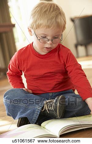 4 year old boy with Downs Syndrome reading View Large Photo Image Stock Photo - 4 year old boy with Downs Syndrome reading. Fotosearch