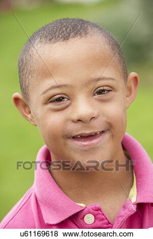 Stock Photo - 9 year old boy with Downs Syndrome. Fotosearch