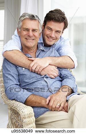 Adult father and son relaxing at home View Large Photo Image Stock Photo - Adult father and son relaxing at home. Fotosearch