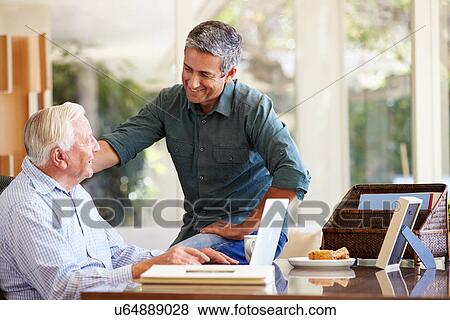 Adult Son Helping Father With Laptop View Large Photo Image Stock Photo - Adult Son Helping Father With Laptop. Fotosearch