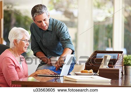 Adult Son Helping Mother With Laptop View Large Photo Image Stock Photography - Adult Son Helping Mother With Laptop. Fotosearch
