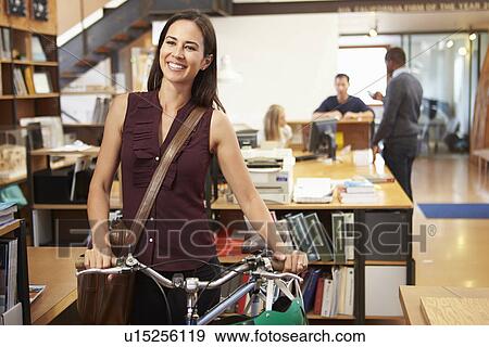 Architect Arrives At Work On Bike Pushing It Through Office View Large Photo Image Stock Photo - Architect Arrives At Work On Bike Pushing It Through Office. Fotosearch