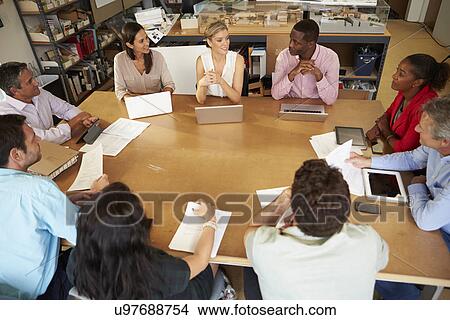 Picture - Architects Sitting At Table Meeting With Laptops And Tablets. Fotosearch