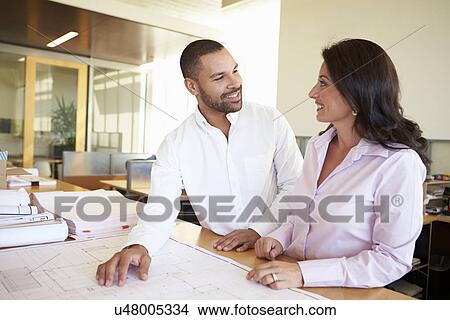 Architects Studying Plans In Modern Office Together View Large Photo Image Picture - Architects Studying Plans In Modern Office Together. Fotosearch