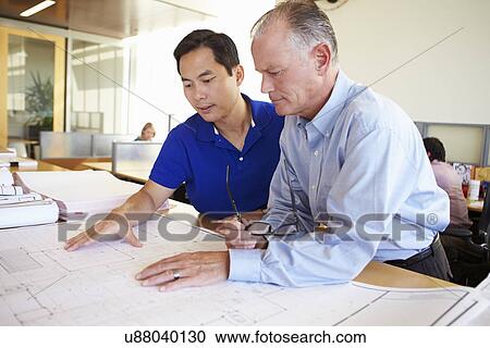 Architects Studying Plans In Modern Office Together View Large Photo Image Stock Image - Architects Studying Plans In Modern Office Together. Fotosearch