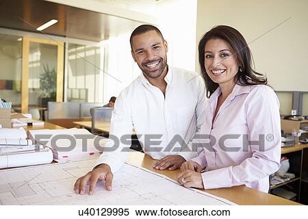 Architects Studying Plans In Modern Office Together View Large Photo Image Stock Photography - Architects Studying Plans In Modern Office Together. Fotosearch