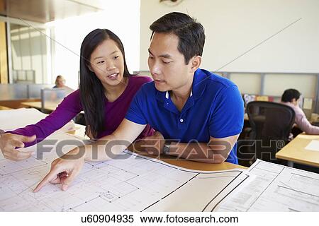 Architects Studying Plans In Modern Office Together View Large Photo Image Stock Photography - Architects Studying Plans In Modern Office Together. Fotosearch