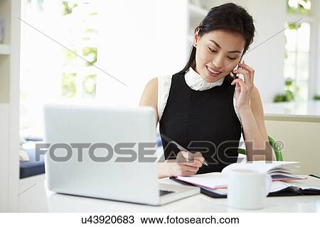 Asian Businesswoman Working From Home Using Mobile Phone View Large Photo Image Stock Image - Asian Businesswoman Working From Home Using Mobile Phone. Fotosearch
