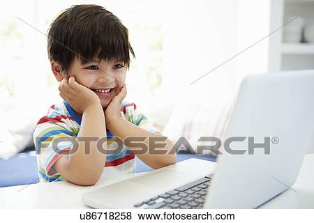 Asian Child Using Laptop At Home View Large Photo Image Stock Photo - Asian Child Using Laptop At Home. Fotosearch