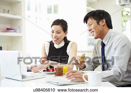 Asian Couple Looking at Laptop Over Breakfast View Large Photo Image Stock Image - Asian Couple Looking at Laptop Over Breakfast. Fotosearch
