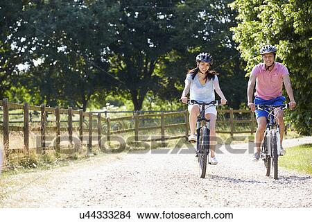 Asian Couple On Cycle Ride In Countryside View Large Photo Image Picture - Asian Couple On Cycle Ride In Countryside. Fotosearch