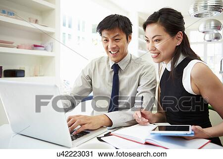 Asian Couple Working From Home Looking At Personal Finances View Large Photo Image Stock Image - Asian Couple Working From Home Looking At Personal Finances. Fotosearch