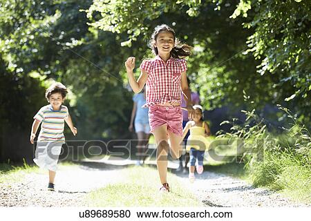 Asian Family Enjoying Walk In Countryside View Large Photo Image Stock Image - Asian Family Enjoying Walk In Countryside. Fotosearch