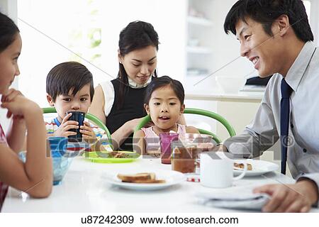 Asian Family Having Breakfast Before Husband Goes To Work View Large Photo Image Stock Photo - Asian Family Having Breakfast Before Husband Goes To Work. Fotosearch
